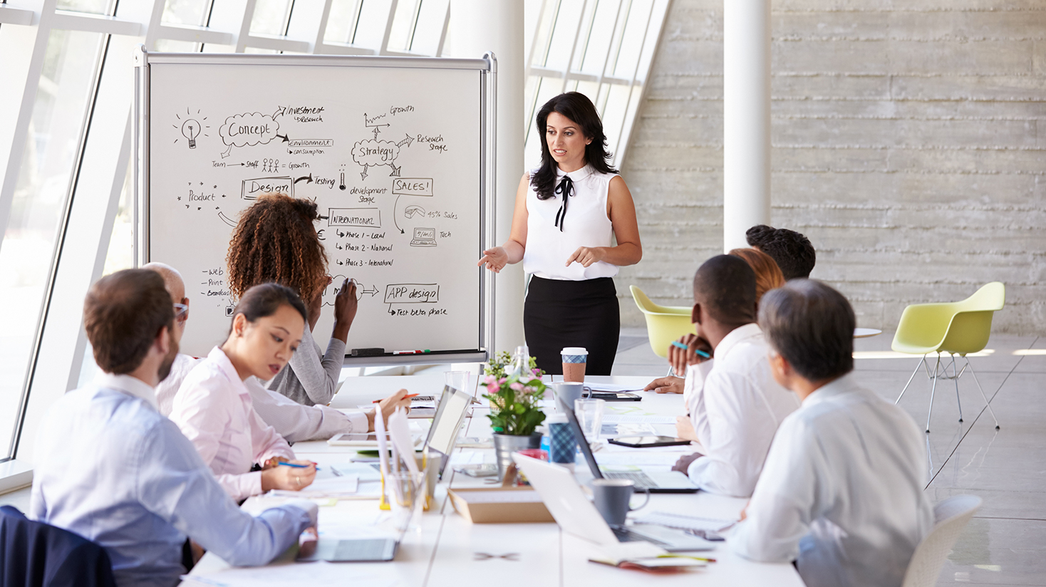 Woman conducting a meeting with employees