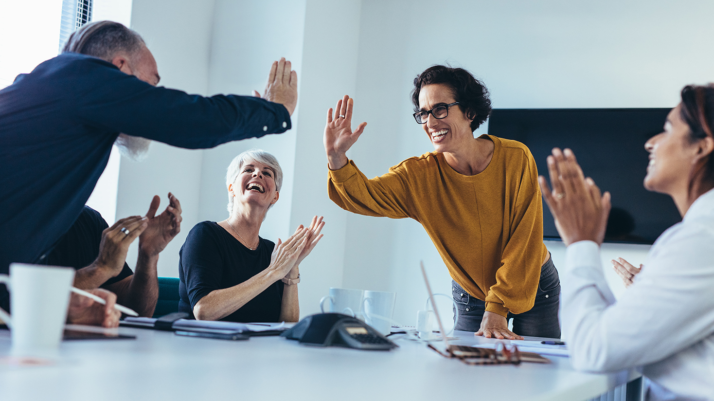 Co-workers giving each other hi fives