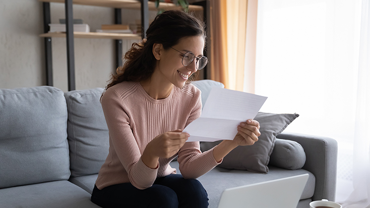 Woman at home reading mail