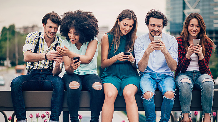 Group of young people using their phones