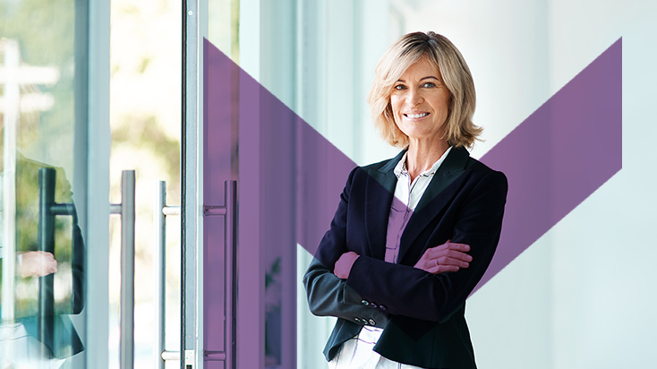 Middle aged female mortgage agent smiling with arms folded