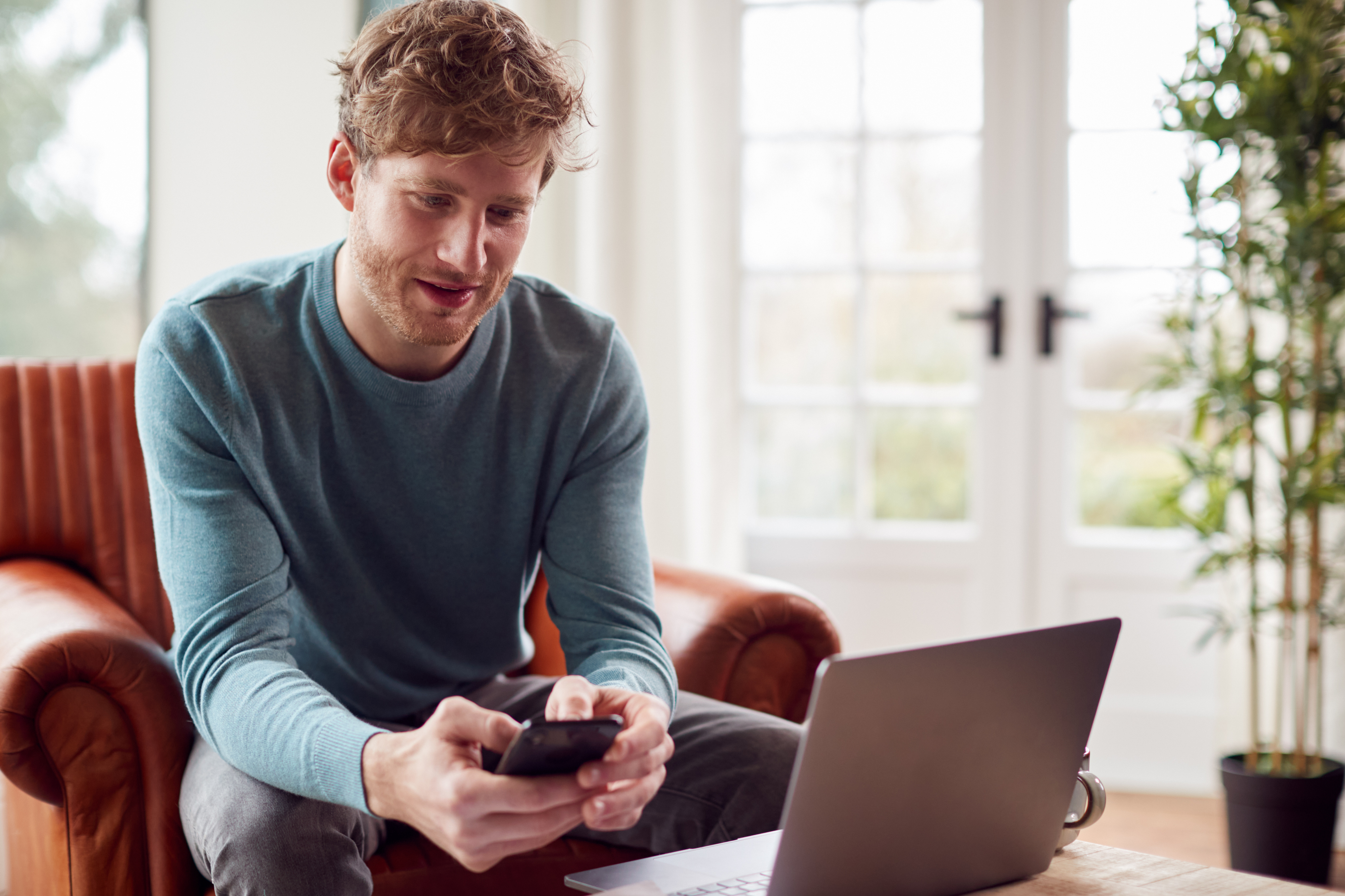 25yr old with phone and laptop